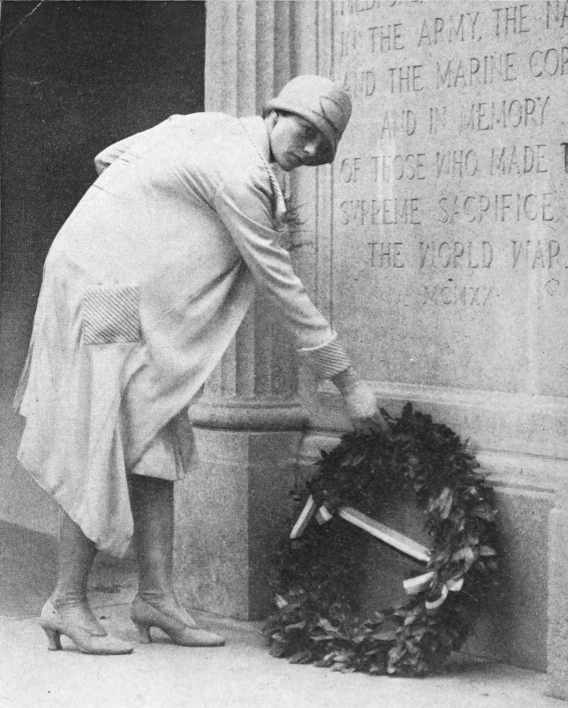 Photo full shot Earhart laying wreath at the base of
                the Medford, Massachusetts Honor Roll Memorial