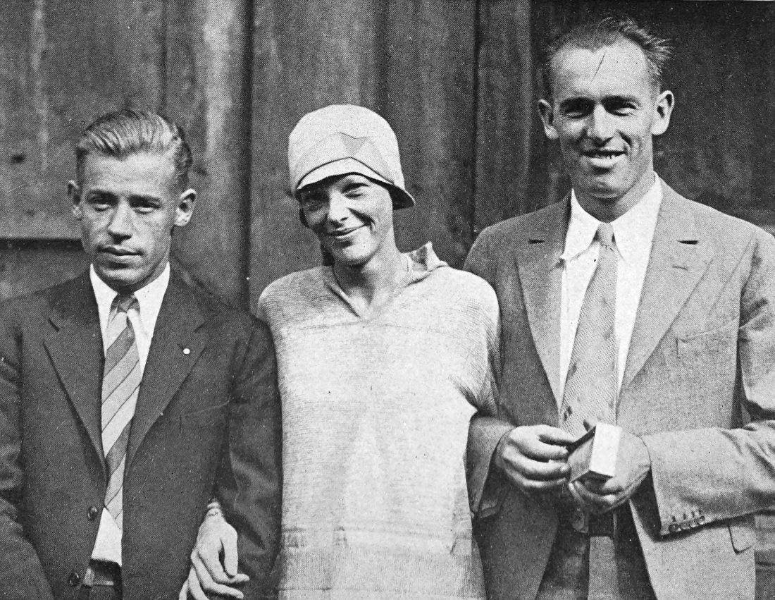 Photo medium shot of Stultz, Earhart, and Gordon with
                arms interlinked