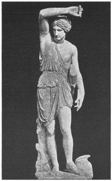 An Amazon stands with one arm raised above her head